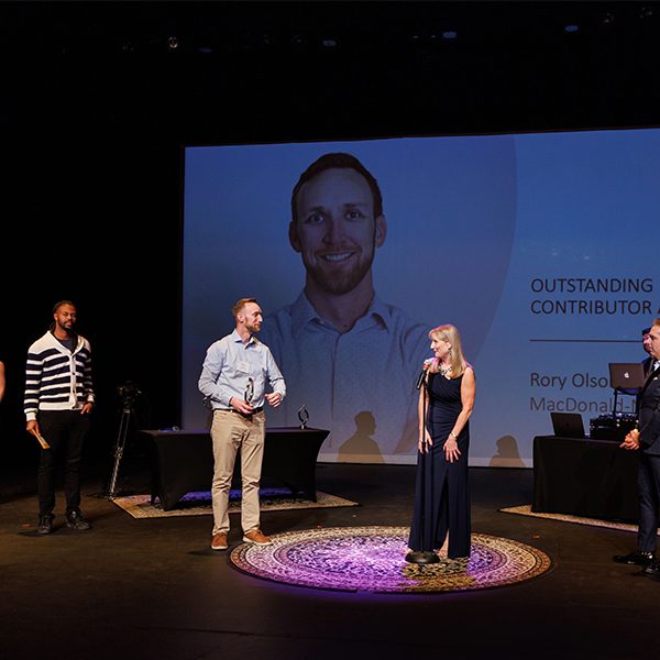 People on stage receiving MCA Award